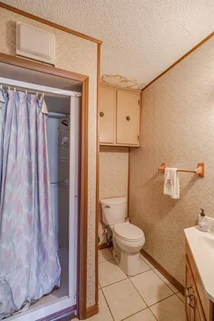 a view of empty room with wooden walls