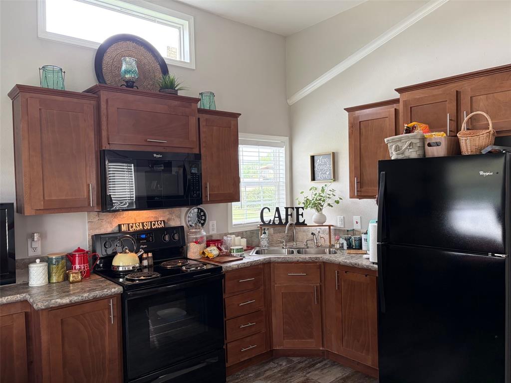 370 Sioux Quitman, TX 75783 - Photo 12 of 34 a kitchen with stainless steel appliances granite countertop a sink stove and refrigerator