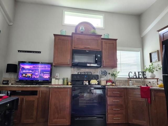 370 Sioux Quitman, TX 75783 - Photo 4 of 34 a kitchen with stainless steel appliances a stove and a microwave