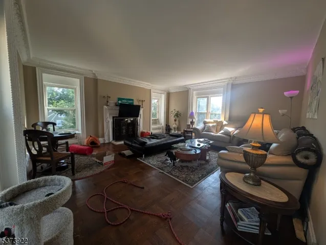 a living room with furniture a window and a flat screen tv