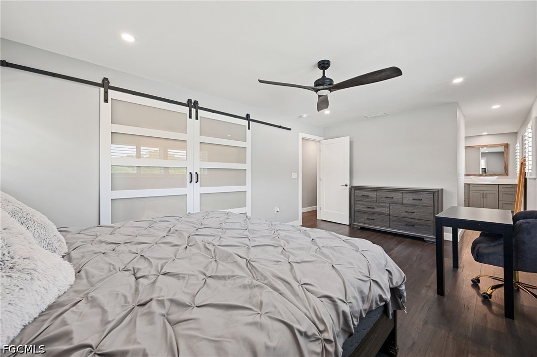 4220 Staley Road Fort Myers, FL 33905 - Photo 22 of 47 a bedroom with a bed a table and a chandelier