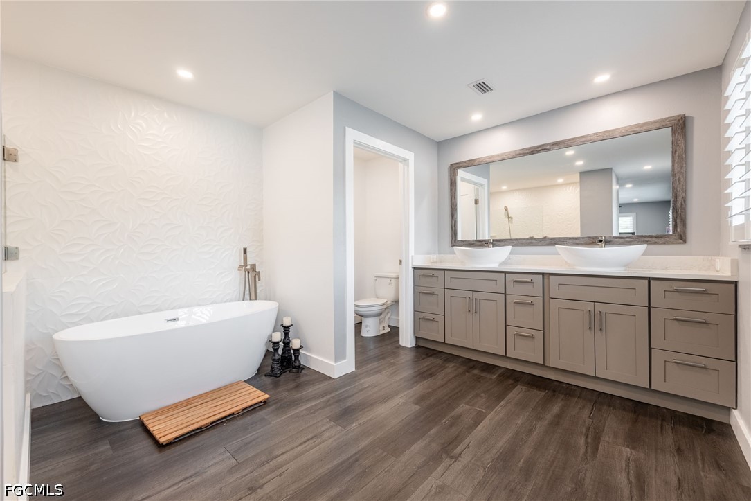 4220 Staley Road Fort Myers, FL 33905 - Photo 23 of 47 a spacious bathroom with a double vanity sink and a mirror
