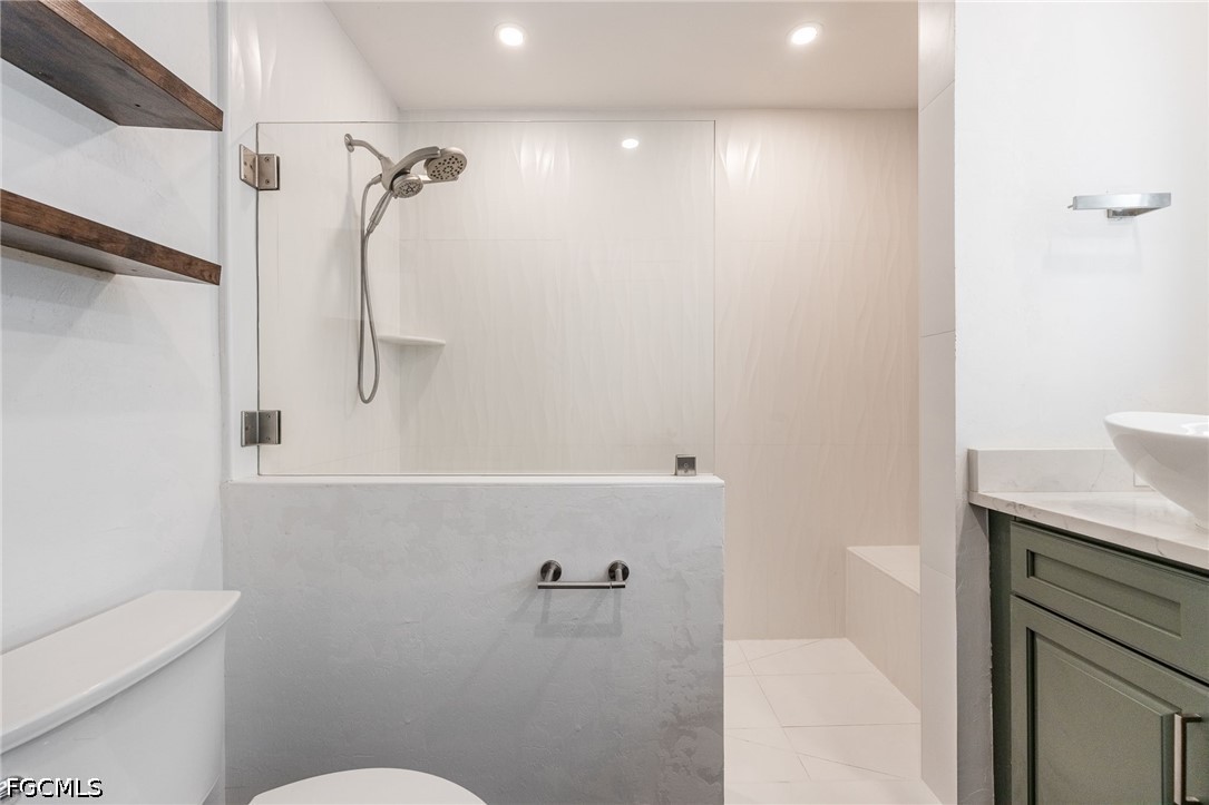 4220 Staley Road Fort Myers, FL 33905 - Photo 28 of 47 a bathroom with a granite countertop sink toilet and shower