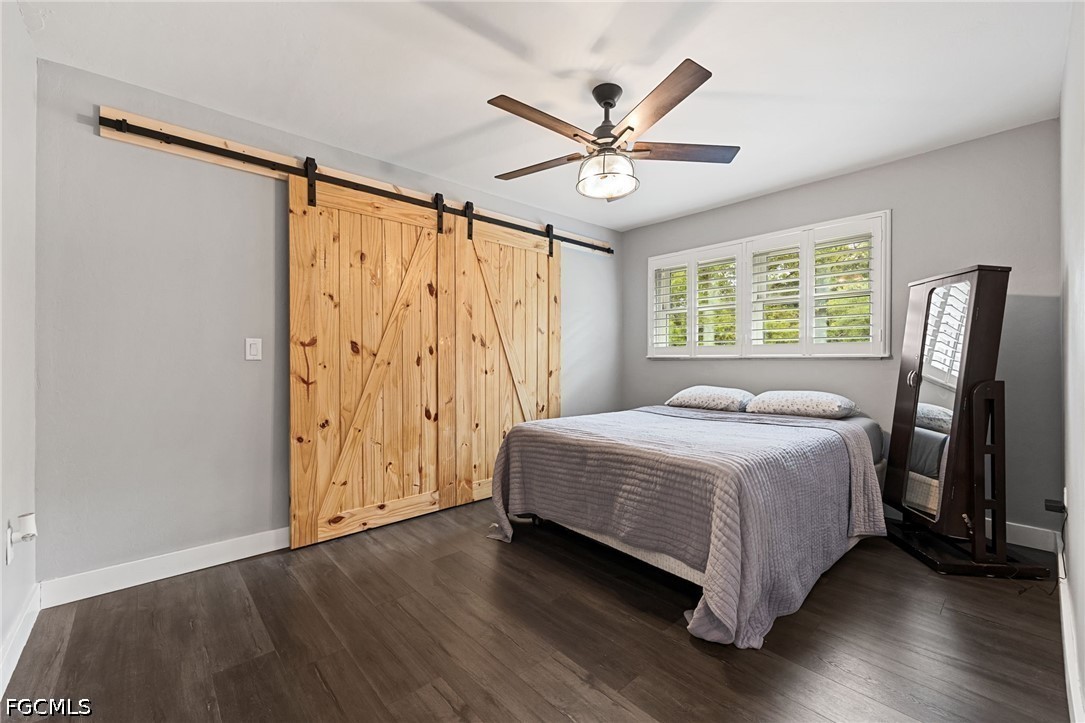 4220 Staley Road Fort Myers, FL 33905 - Photo 29 of 47 a bedroom with a bed and wooden floor