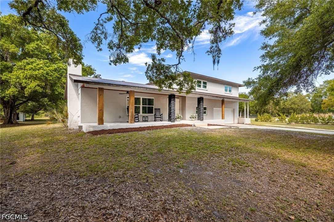 4220 Staley Road Fort Myers, FL 33905 - Photo 3 of 47 a front view of house with yard and green space