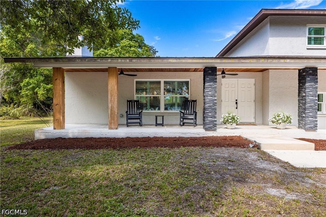 4220 Staley Road Fort Myers, FL 33905 - Photo 4 of 47 a front view of a house with garden