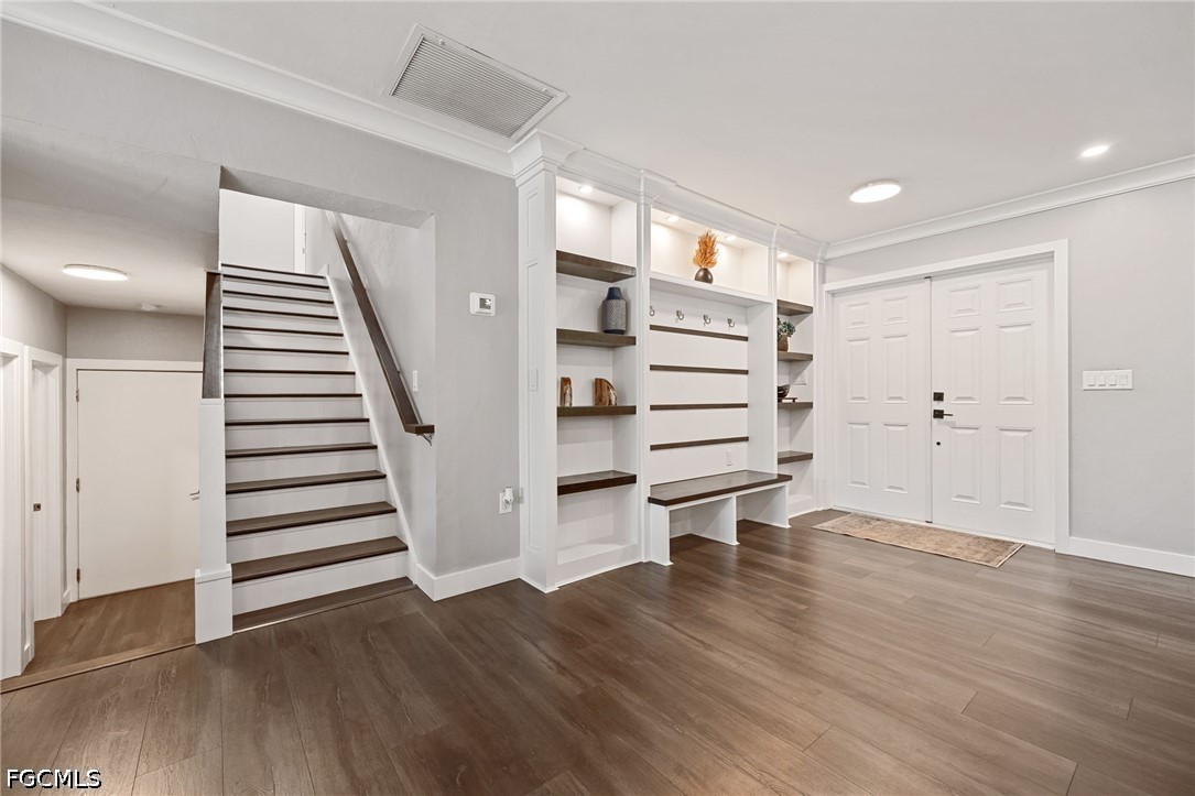 4220 Staley Road Fort Myers, FL 33905 - Photo 7 of 47 an empty room with wooden floor stairs and white walls