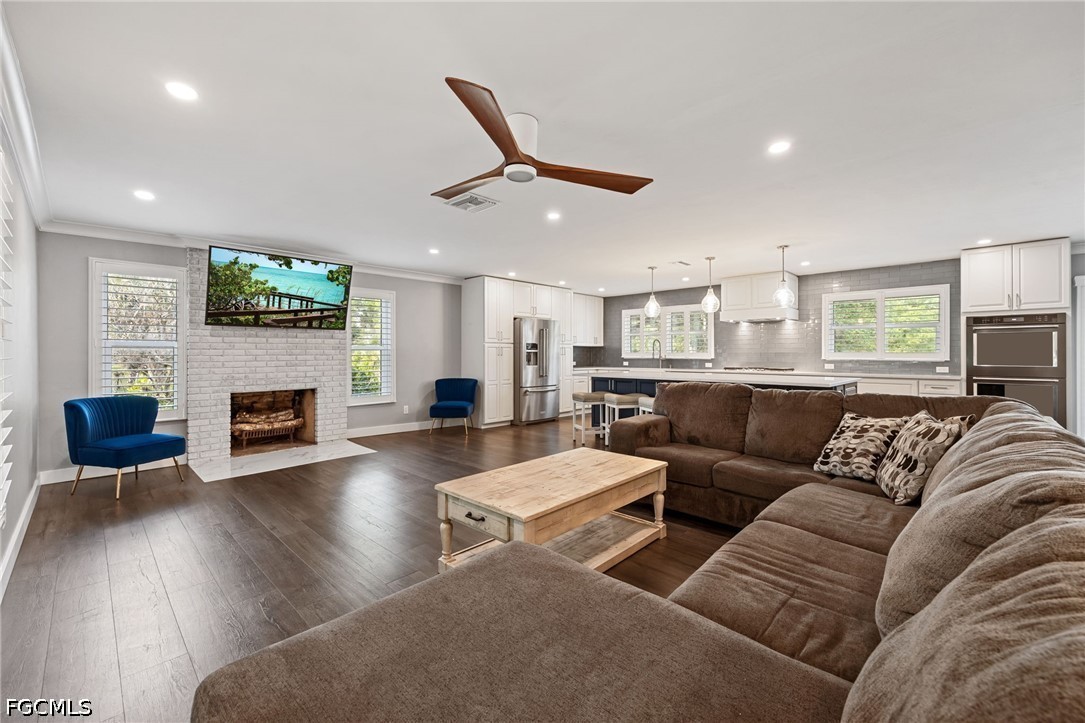 4220 Staley Road Fort Myers, FL 33905 - Photo 9 of 47 a living room with furniture flat screen tv and a fireplace