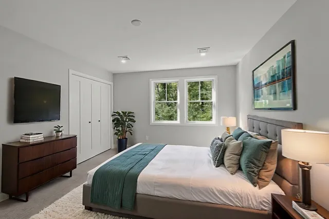 a bedroom with a bed and a flat screen tv