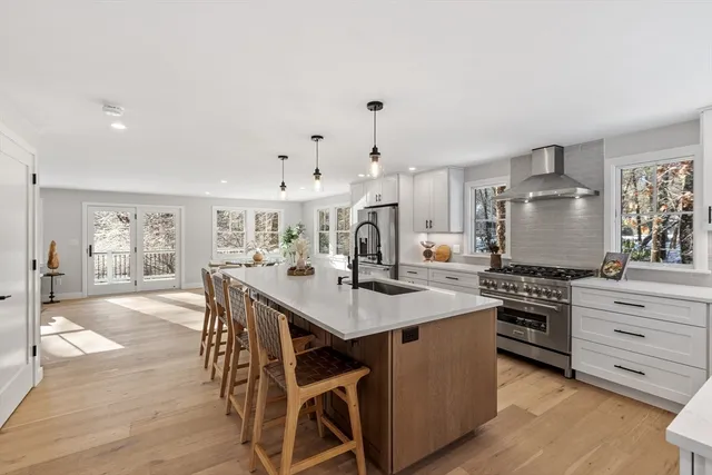 a kitchen with stainless steel appliances a stove a sink dishwasher and a refrigerator