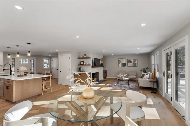 a living room with furniture and kitchen view