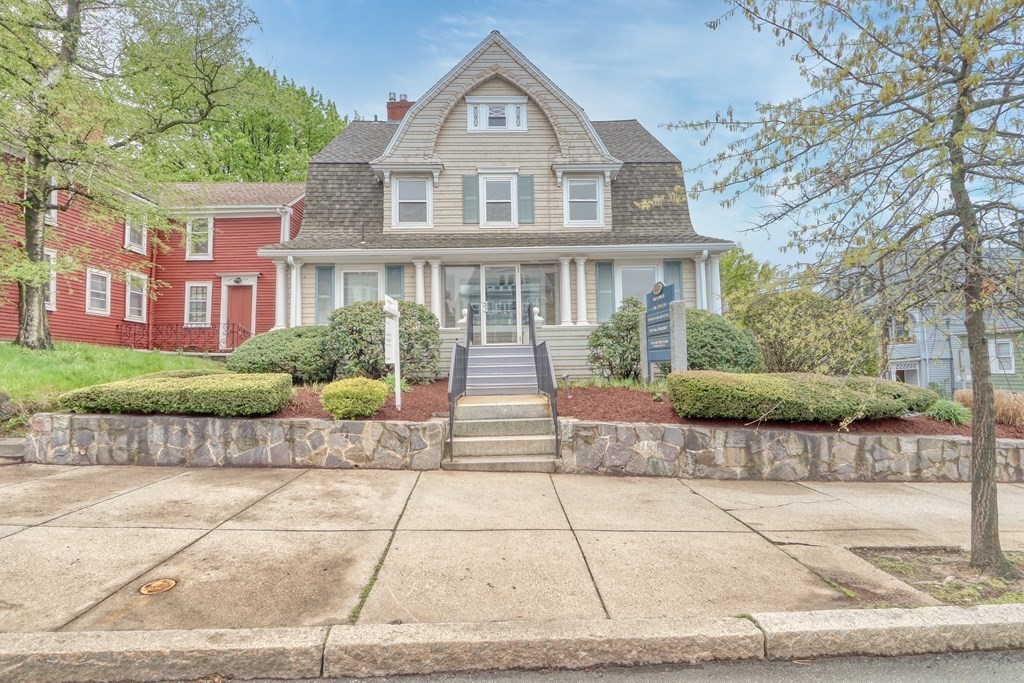 a front view of a house with a garden