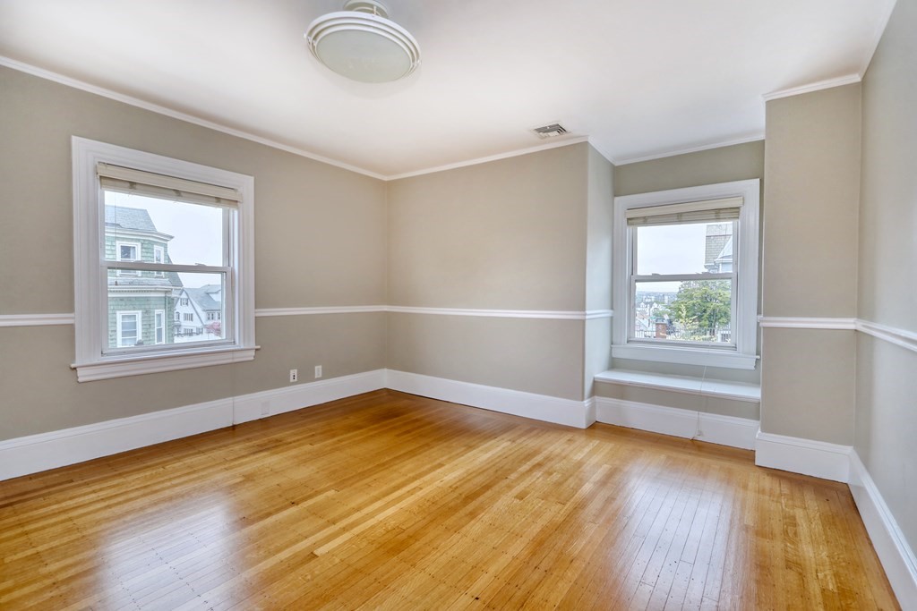 440 Broadway Somerville, MA 02145 - Photo 13 of 27 wooden floor in an empty room with a window