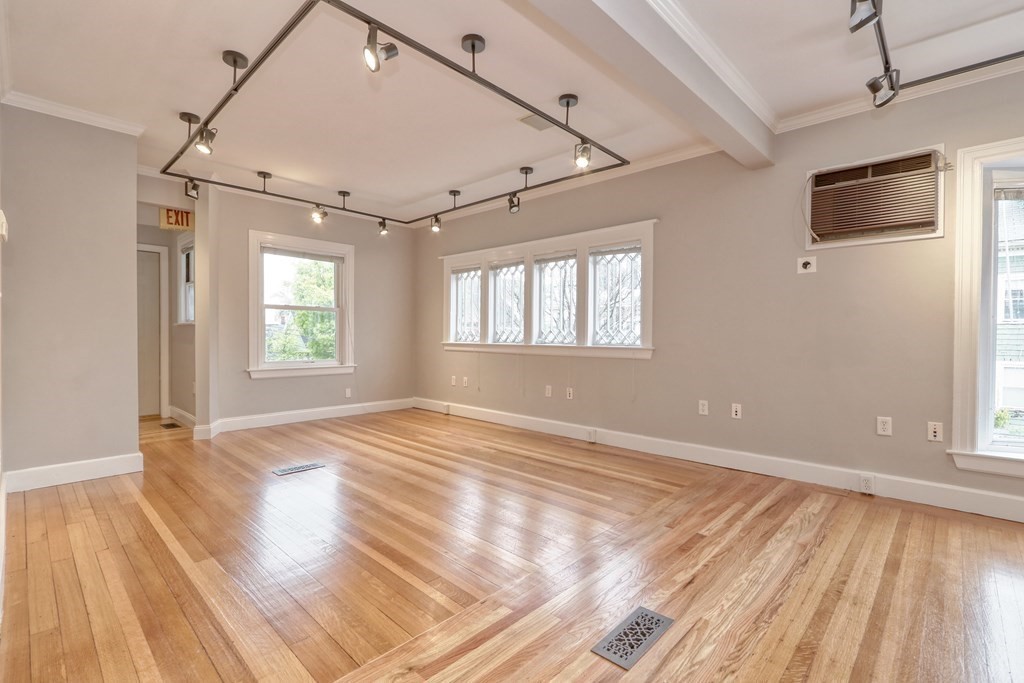 440 Broadway Somerville, MA 02145 - Photo 2 of 27 an empty room with wooden floor and windows