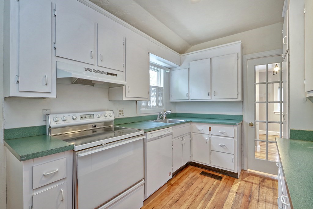 440 Broadway Somerville, MA 02145 - Photo 5 of 27 a kitchen with stainless steel appliances granite countertop a sink stove and cabinets