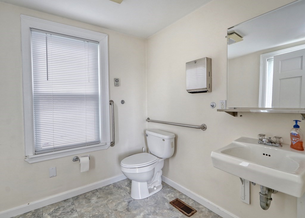 440 Broadway Somerville, MA 02145 - Photo 8 of 27 a white toilet sitting next to a bathroom sink