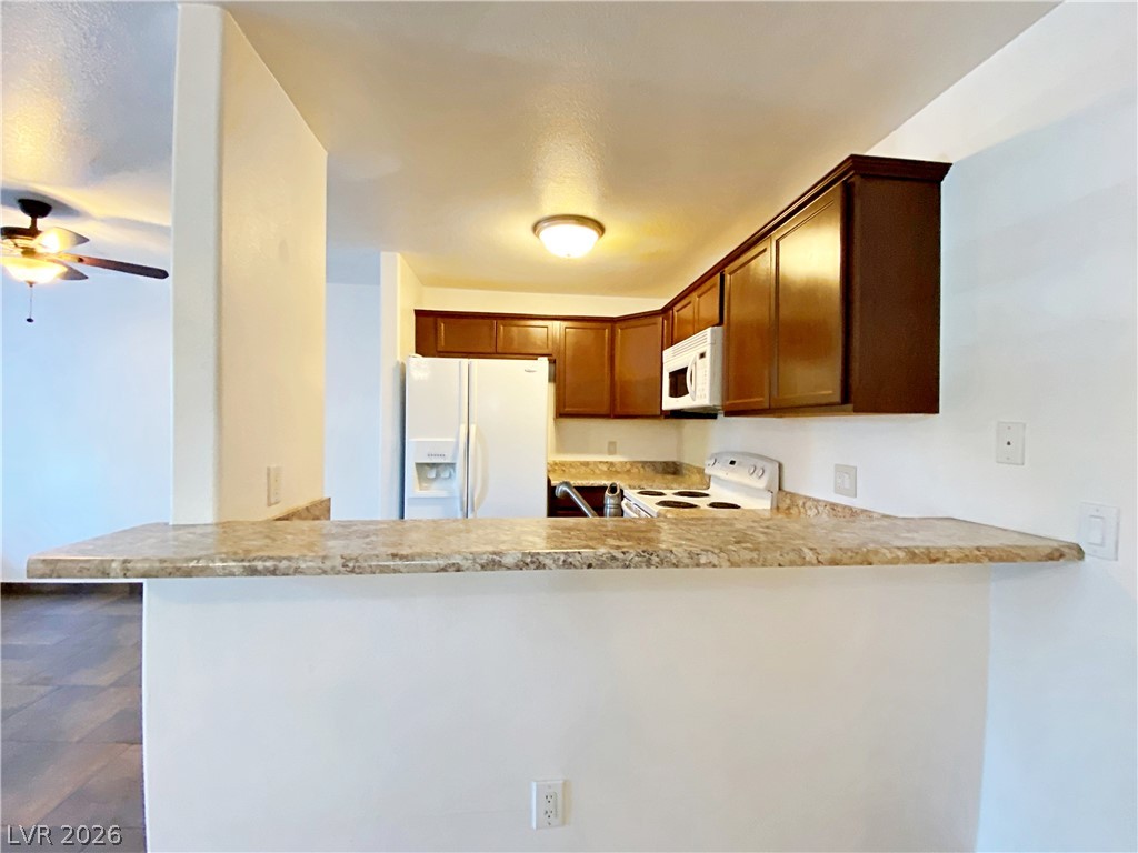 3145 East Flamingo Road, Unit 1128 Las Vegas, NV 89121 - Photo 6 of 19 A functional kitchen with solid cabinetry and practical countertop space.