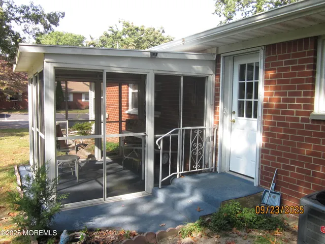 a view of a porch with a chairs and table in a patio
