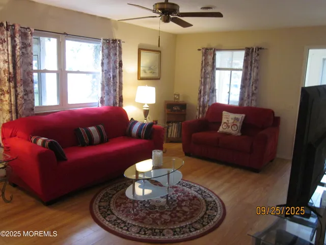a living room with furniture a fireplace and a window