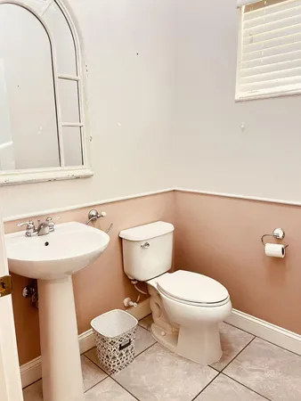 a bathroom with a sink toilet and a mirror