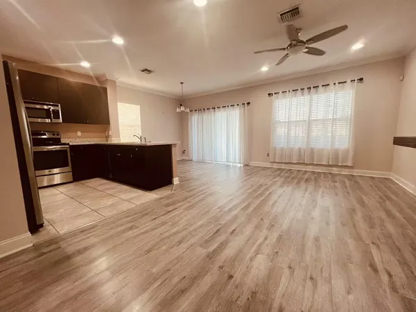 a large room with wooden floor and windows