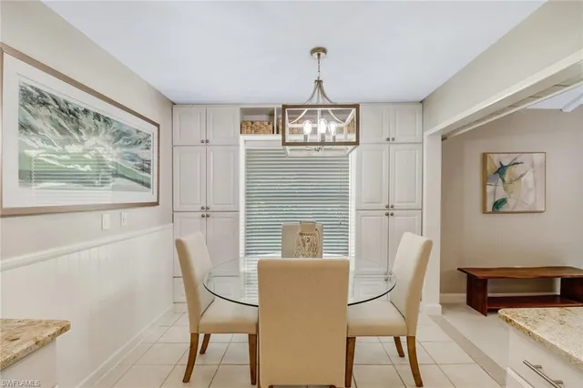 a view of a dining room with furniture a chandelier and wooden floor