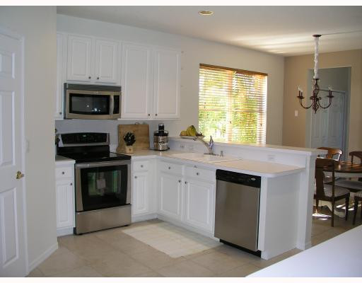 12314 Melrose Way Boca Raton, FL 33428 - Photo 6 of 12 a kitchen with stainless steel appliances granite countertop a stove a sink and a microwave