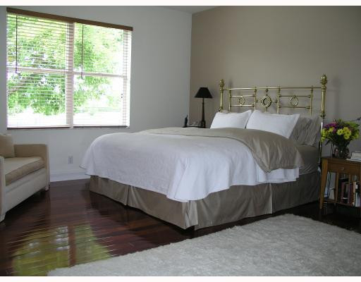 12314 Melrose Way Boca Raton, FL 33428 - Photo 8 of 12 a bed sitting in a bedroom next to a window