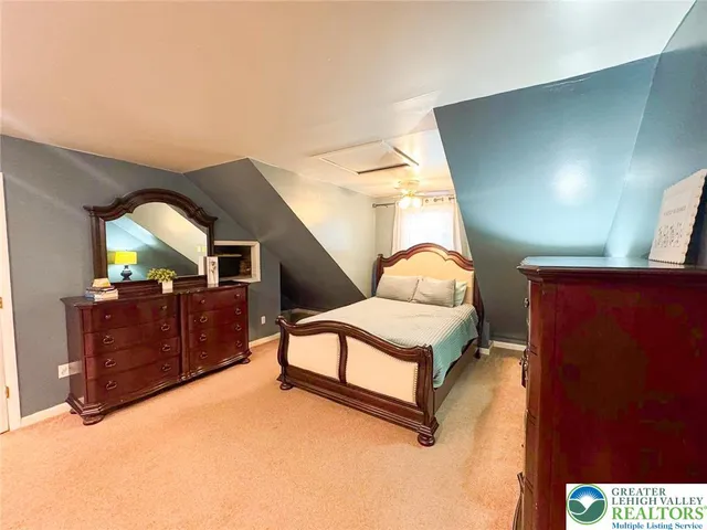 a bedroom with a bed and a dresser