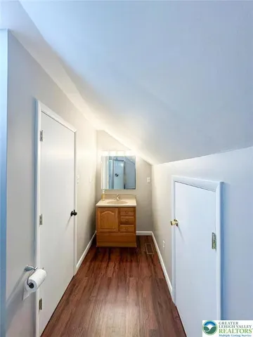 a view of bedroom with wooden floor