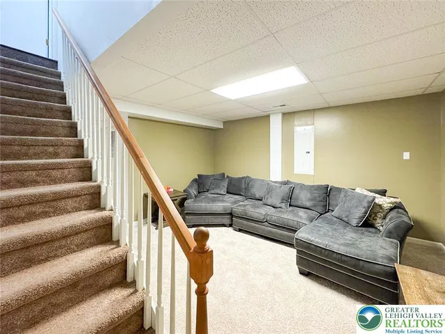 a living room with furniture and stairs