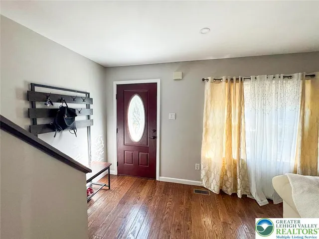 a view of room with window and wooden floor