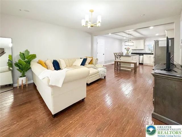 a living room with furniture and a chandelier