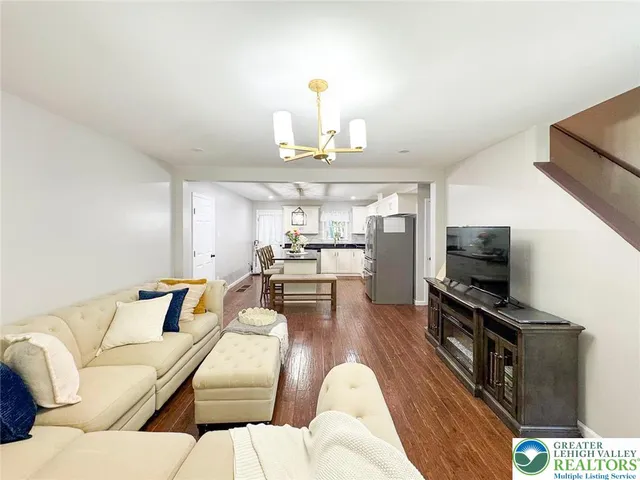 a living room with furniture flat screen tv and outdoor view