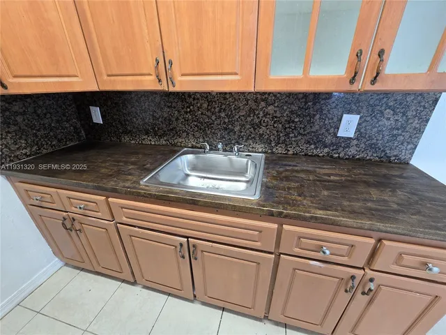 a kitchen with granite countertop white cabinets and white countertops