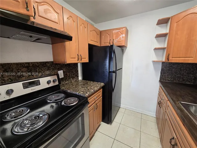a kitchen with stainless steel appliances granite countertop a stove and a refrigerator
