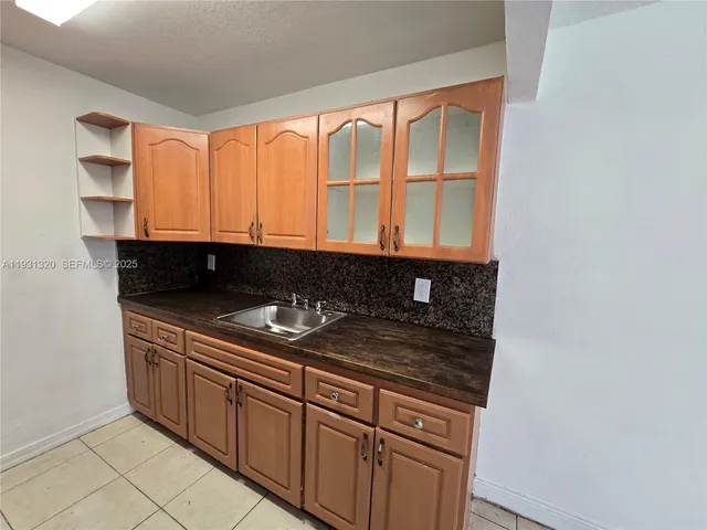 a kitchen with granite countertop cabinets and sink