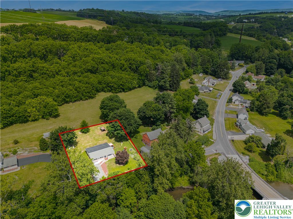 50 Kohls Road Northampton, PA 18067 - Photo 46 of 54 Vast green landscape with a quiet rural neighborhood, featuring a charming residence and flowing creek.