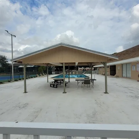 a view of a patio with table and chairs under an umbrella