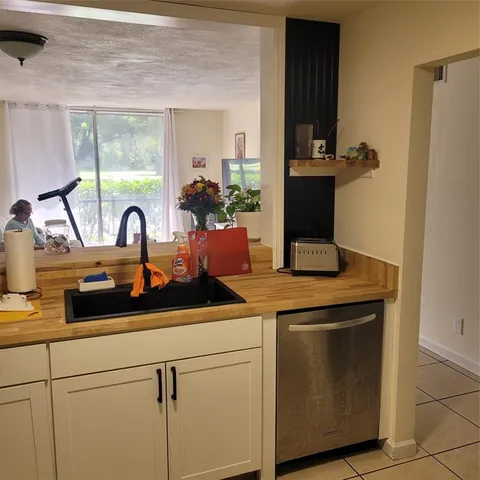 a kitchen with a sink and cabinets
