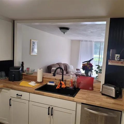 a kitchen with a stove and a white cabinets