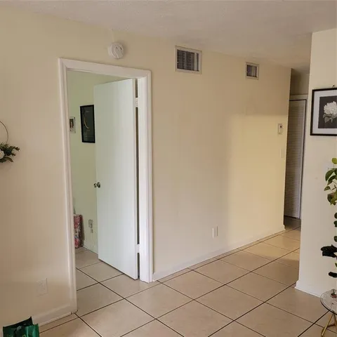 a view of a hallway with closet and bathroom