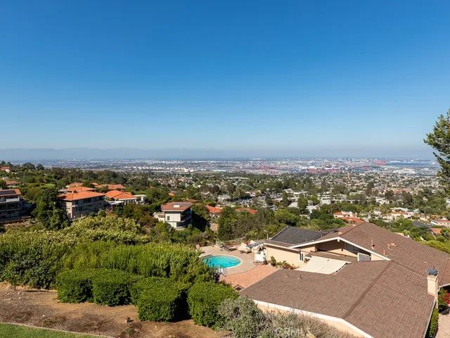 a kitchen with granite countertop a sink cabinets and wooden floor