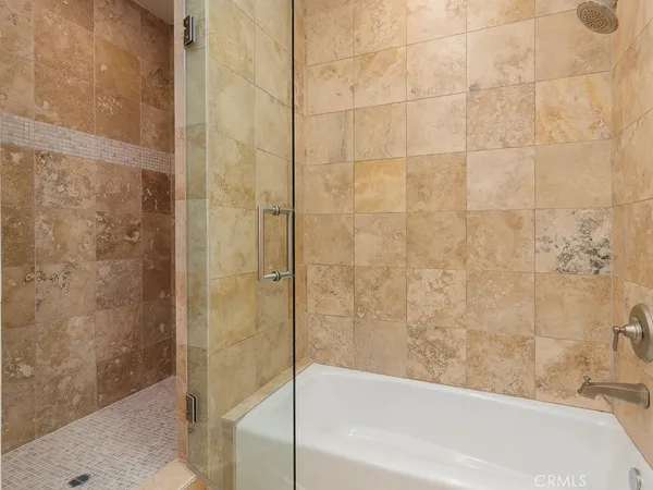 a bathroom with a bathtub and shower
