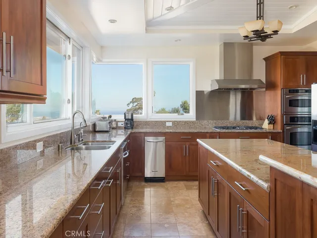 a bathroom with a granite countertop bathtub a sink and a mirror