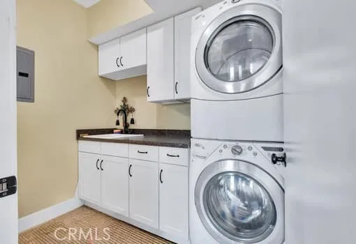 a utility room with sink dryer and washer