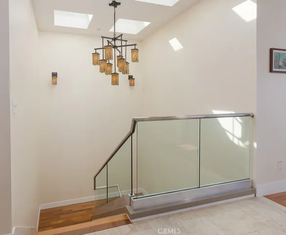 a view of a porch with chairs and floor to ceiling window