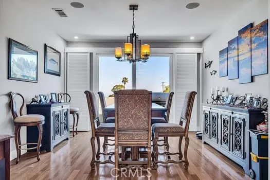 a view of a dining room with furniture wooden floor and chandelier