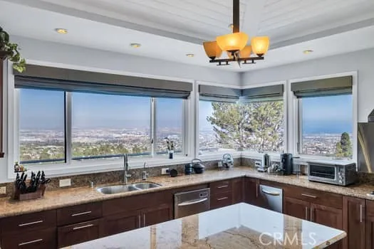 a kitchen with stainless steel appliances granite countertop a sink and a stove