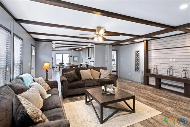 a living room with furniture and wooden floor